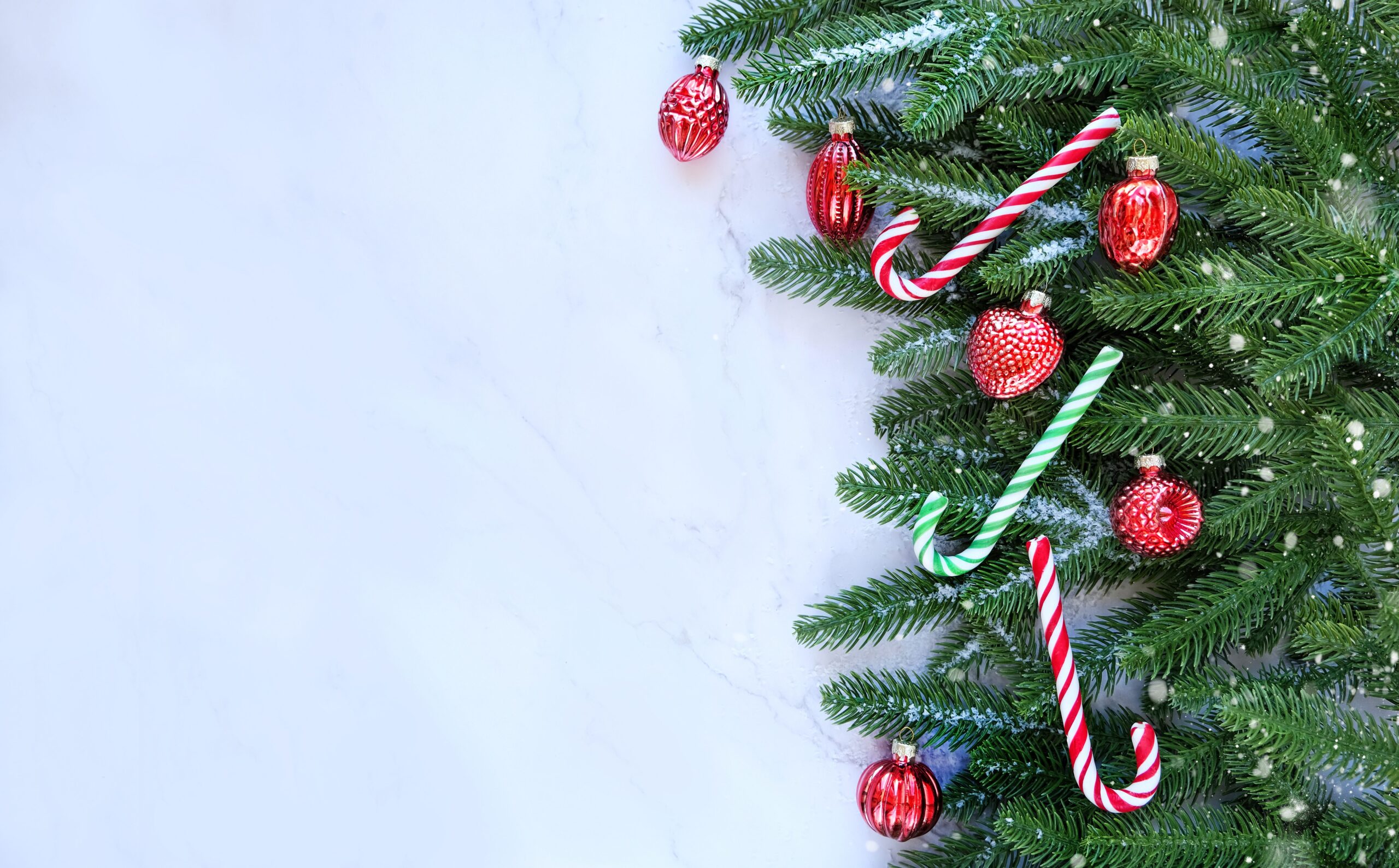 Christmas tree, candy canes, toy decor on marble background